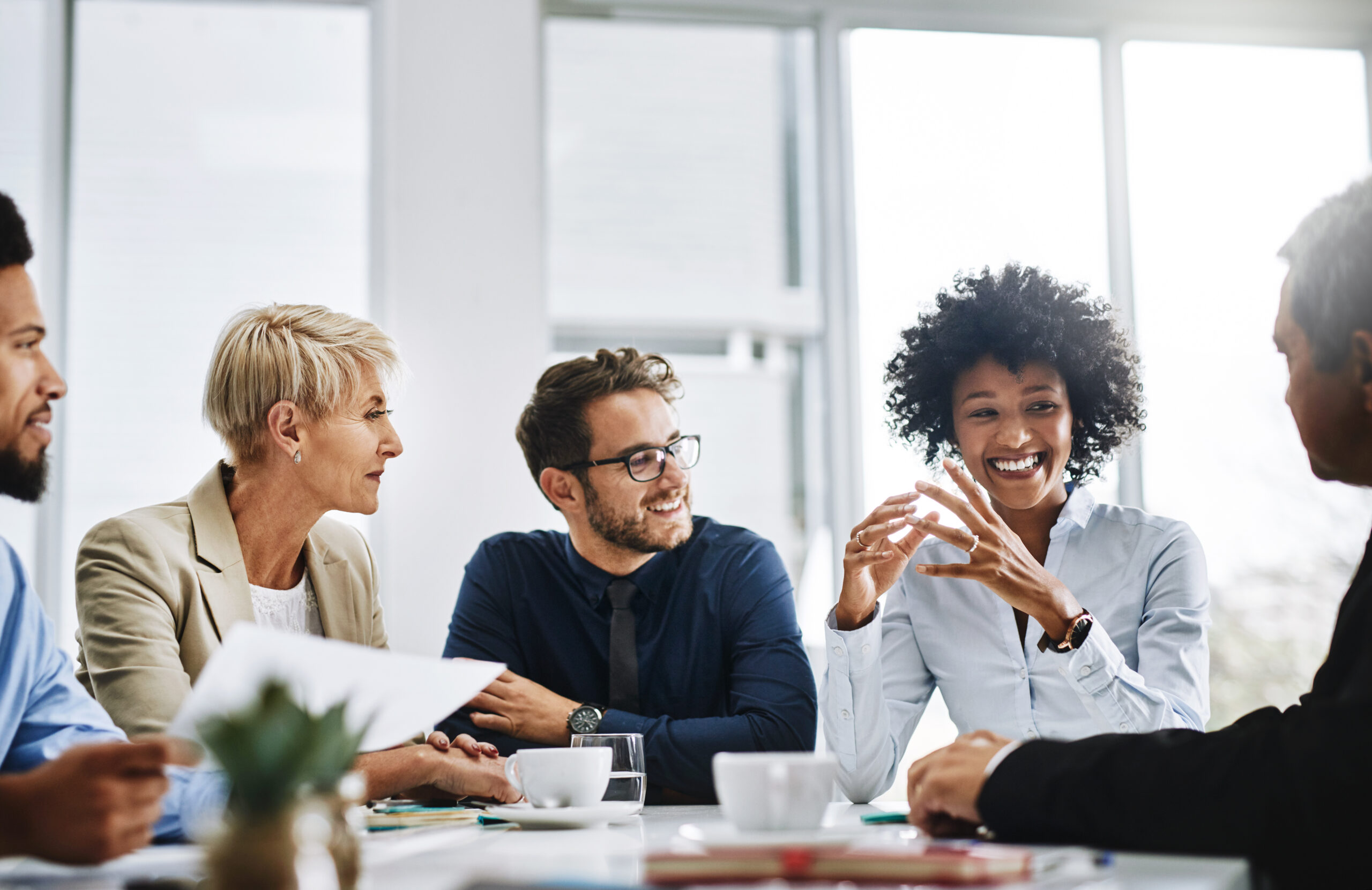 with the help of the whole team, anything is possible. shot of a group of businesspeople sitting together in a meeting. with the help of the whole team, anything is possible. shot of a group of businesspeople sitting together in a meeting.